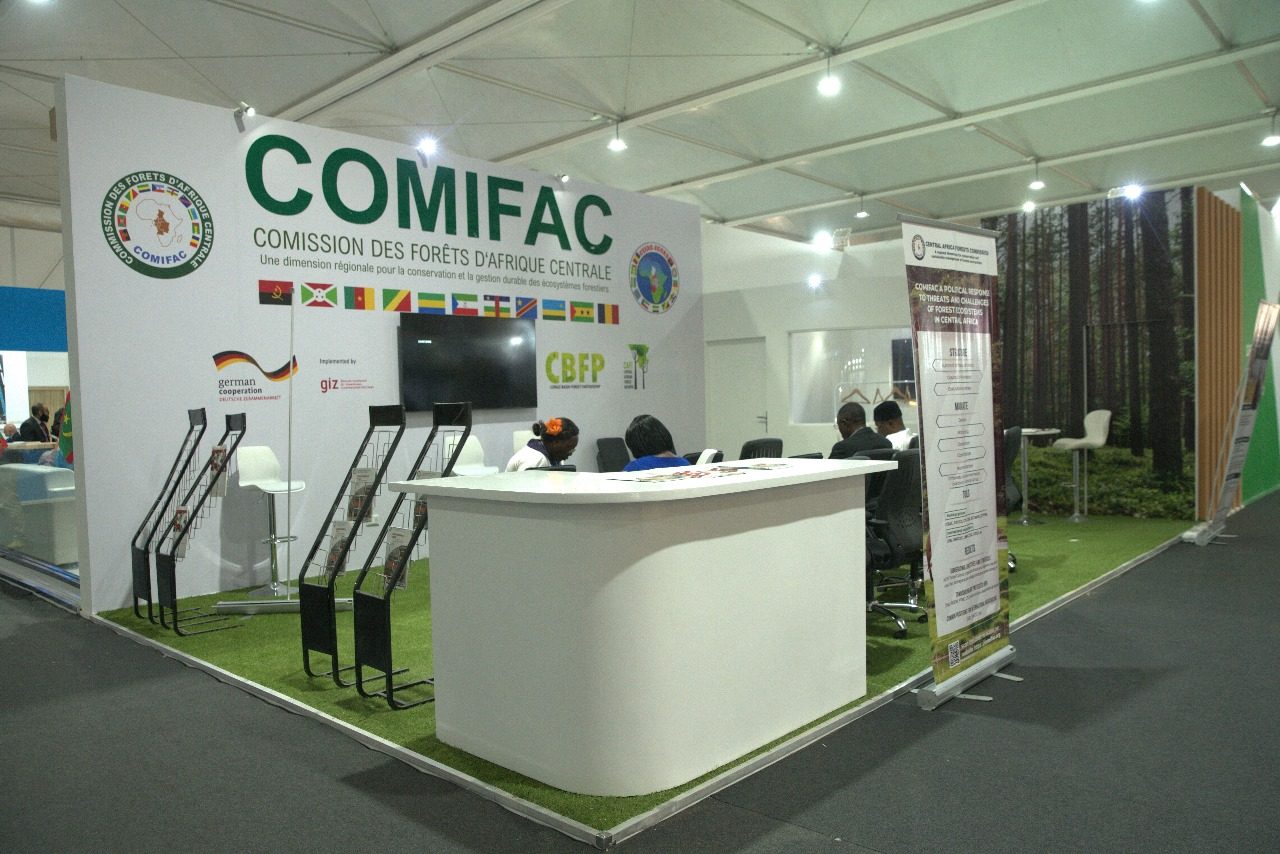 COMIFAC booth at COP27 in Sharm El Sheikh, showcasing a detailed and informative display on Central Africa's forest conservation efforts, with maps, visuals, and materials emphasizing sustainable management of natural resources.