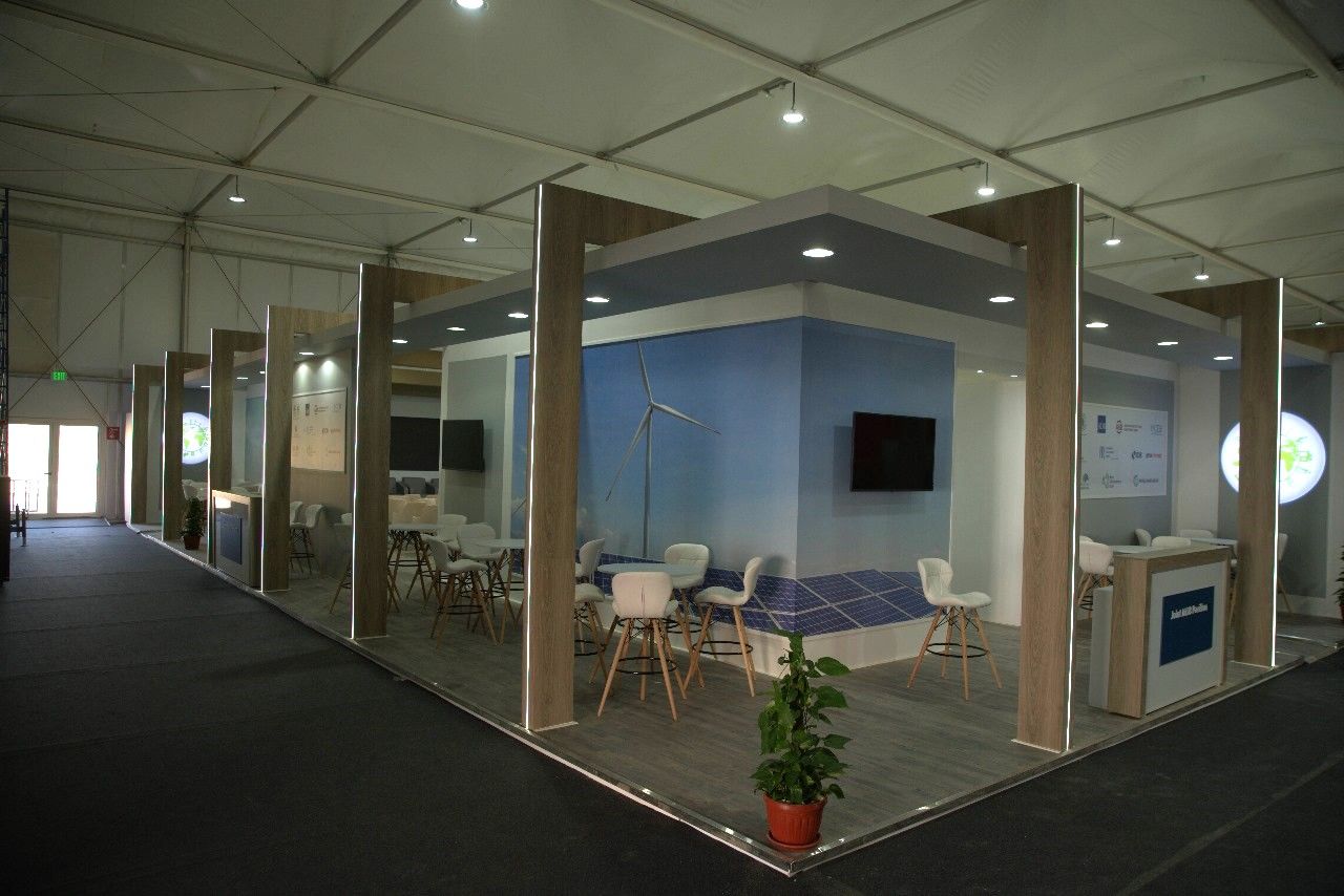 MDB (Multilateral Development Banks) booth at COP27 in Sharm El Sheikh, featuring a sophisticated design with informative displays and interactive elements that illustrate the MDBs' role in financing climate resilience and sustainable development projects.