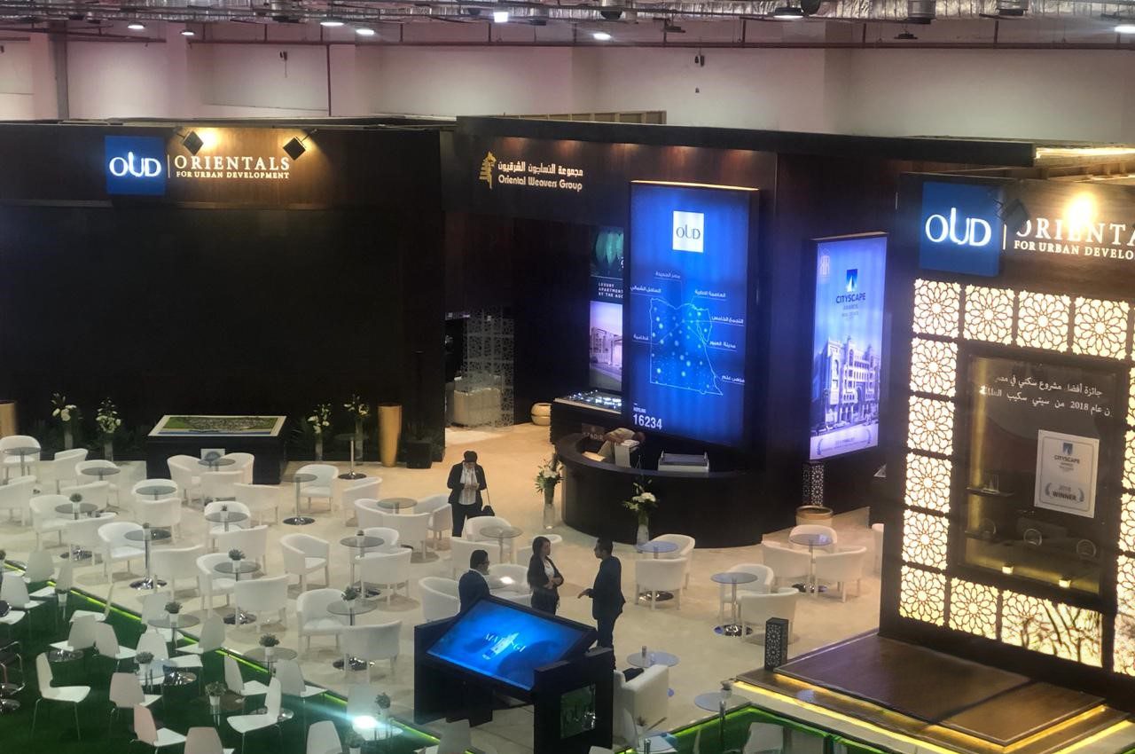 Booth designed for Orientals For Urban Development (OUD) at the 2018 Hazi Misr Exhibition, showcasing modern urban living projects.